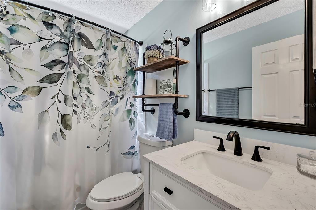 11419 Old Crystal River Road Brooksville, FL 34601 - Photo 13 of 89 a bathroom with a granite countertop sink toilet and mirror