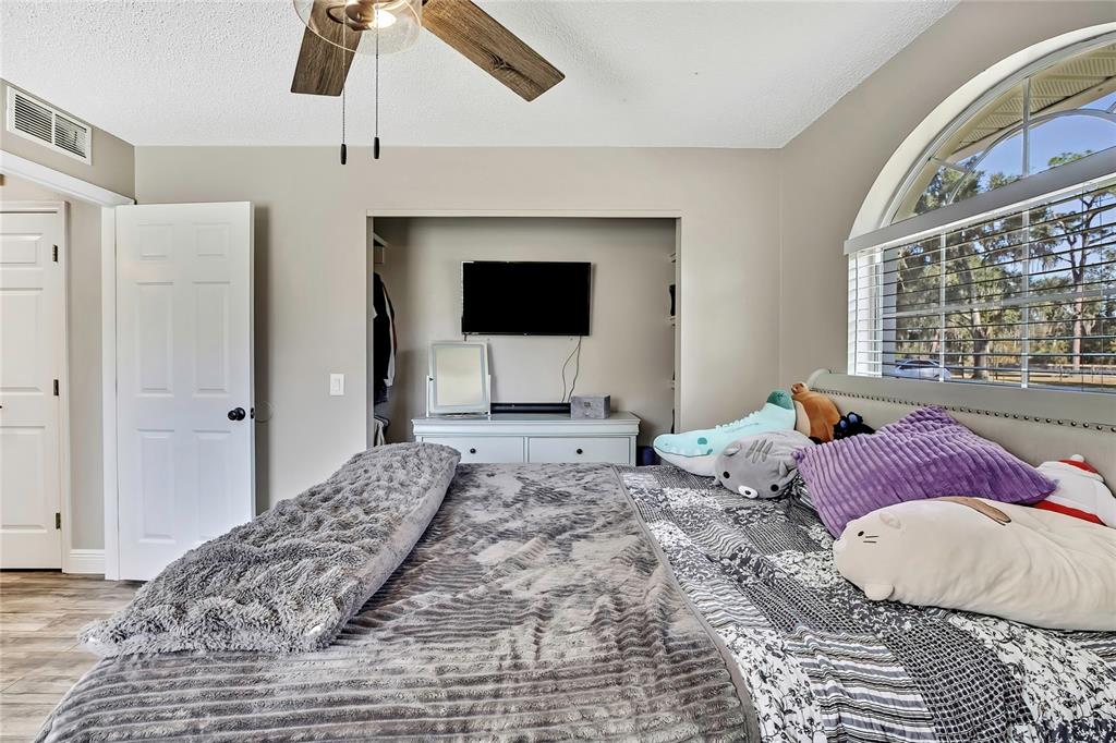 11419 Old Crystal River Road Brooksville, FL 34601 - Photo 30 of 89 a bedroom with a bed and a flat screen tv