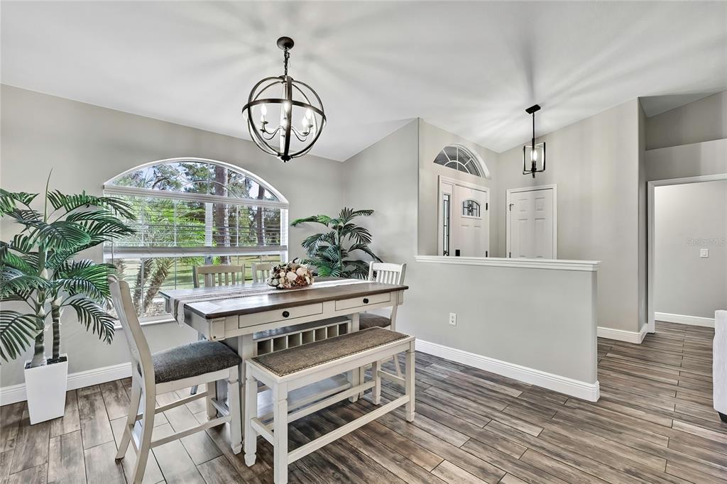 11419 Old Crystal River Road Brooksville, FL 34601 - Photo 3 of 89 a view of a dining room with furniture window and wooden floor