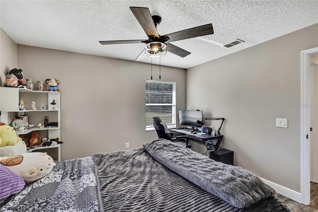 11419 Old Crystal River Road Brooksville, FL 34601 - Photo 31 of 89 a bedroom with a bed and a chandelier