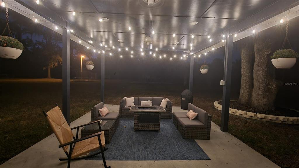 11419 Old Crystal River Road Brooksville, FL 34601 - Photo 51 of 89 a living room with furniture and a chandelier