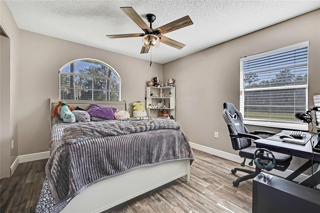 11419 Old Crystal River Road Brooksville, FL 34601 - Photo 10 of 89 a bedroom with a bed window and a table