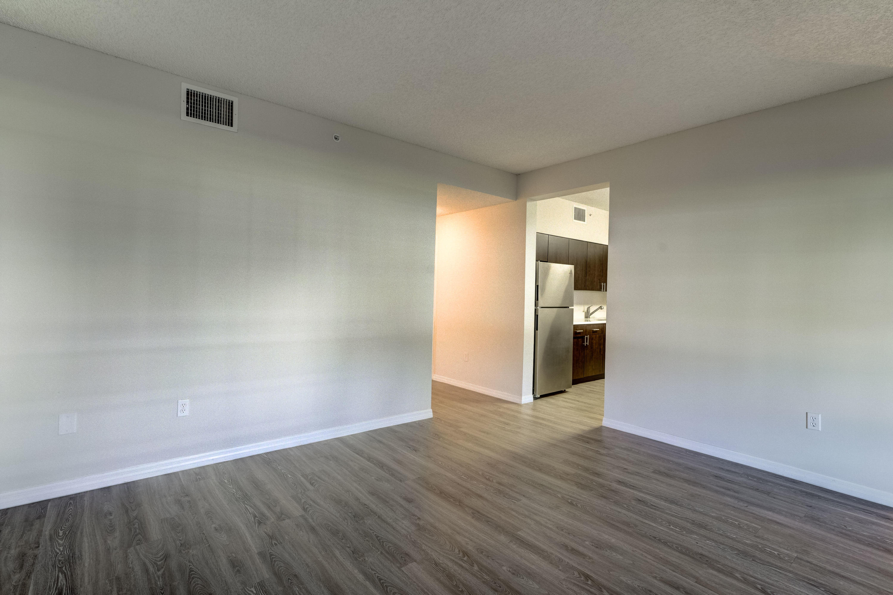 4685 Haverhill Road, Unit B11 West Palm Beach, FL 33417 - Photo 13 of 36 a view of an empty room with wooden floor and a window
