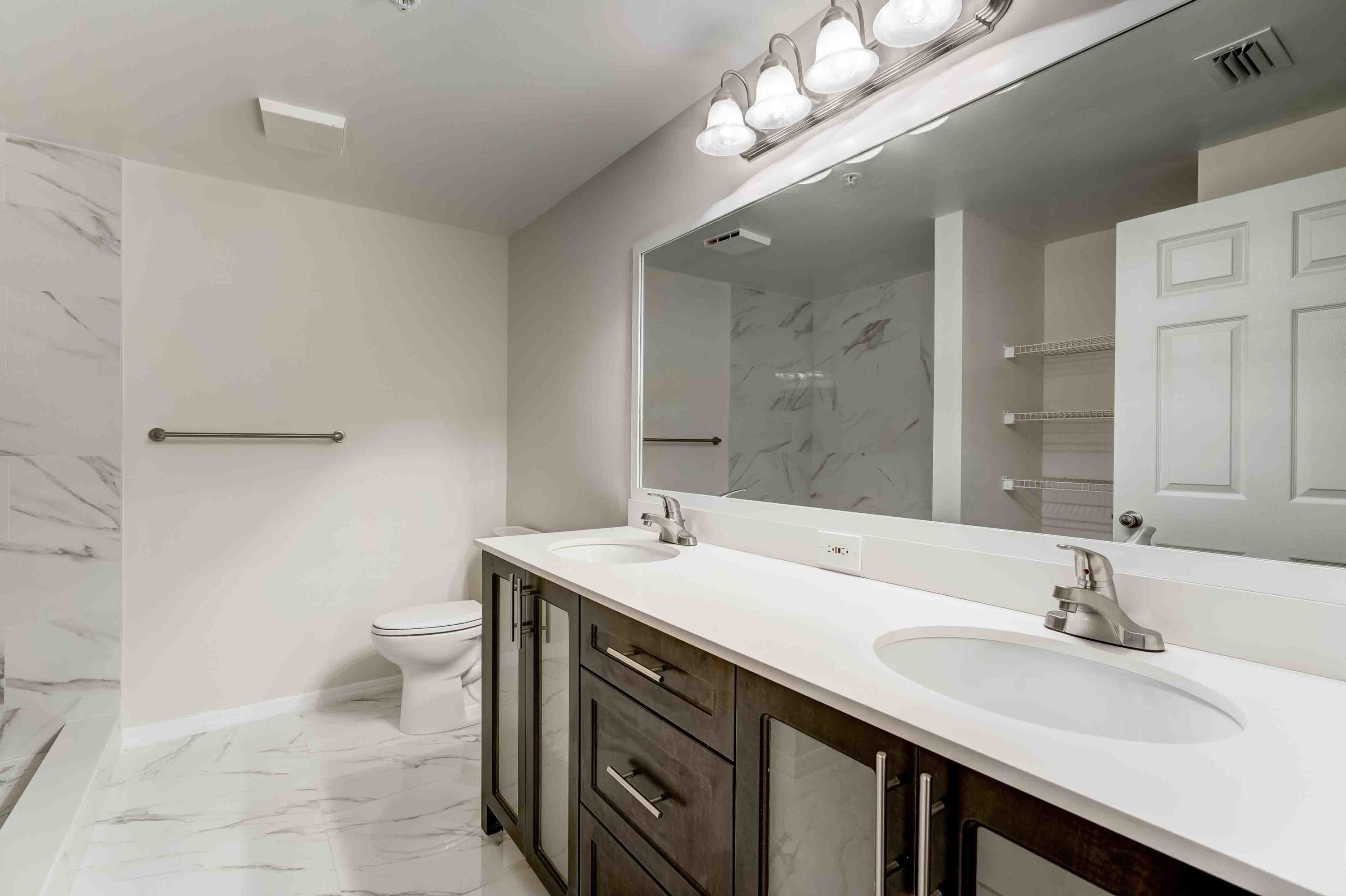 4685 Haverhill Road, Unit B11 West Palm Beach, FL 33417 - Photo 22 of 36 a bathroom with a sink a toilet and a mirror