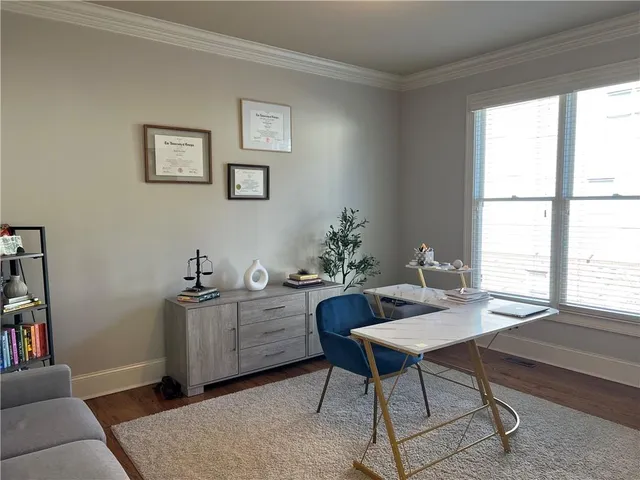 a living room with furniture a ceiling fan and a rug