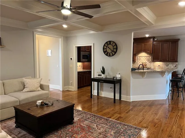 a kitchen with granite countertop a stove a refrigerator and wooden cabinets
