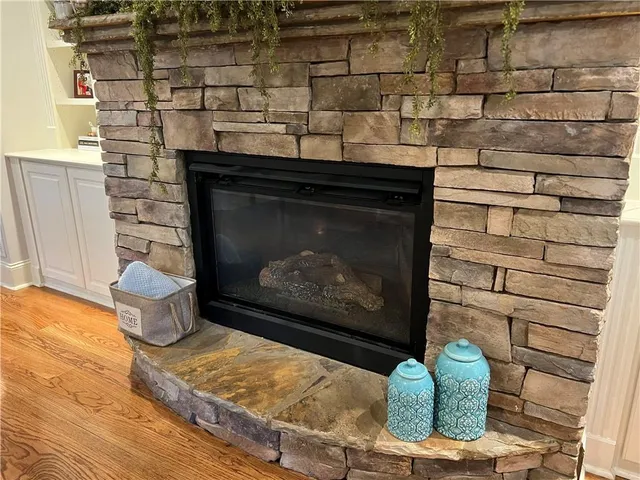 a kitchen with granite countertop wooden cabinets a counter top space and stainless steel appliances