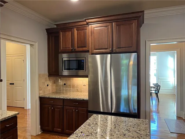 a bathroom with a sink a mirror and a potted plant