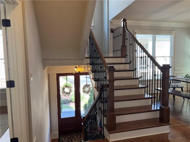 a view of a chandelier in hallway with windows