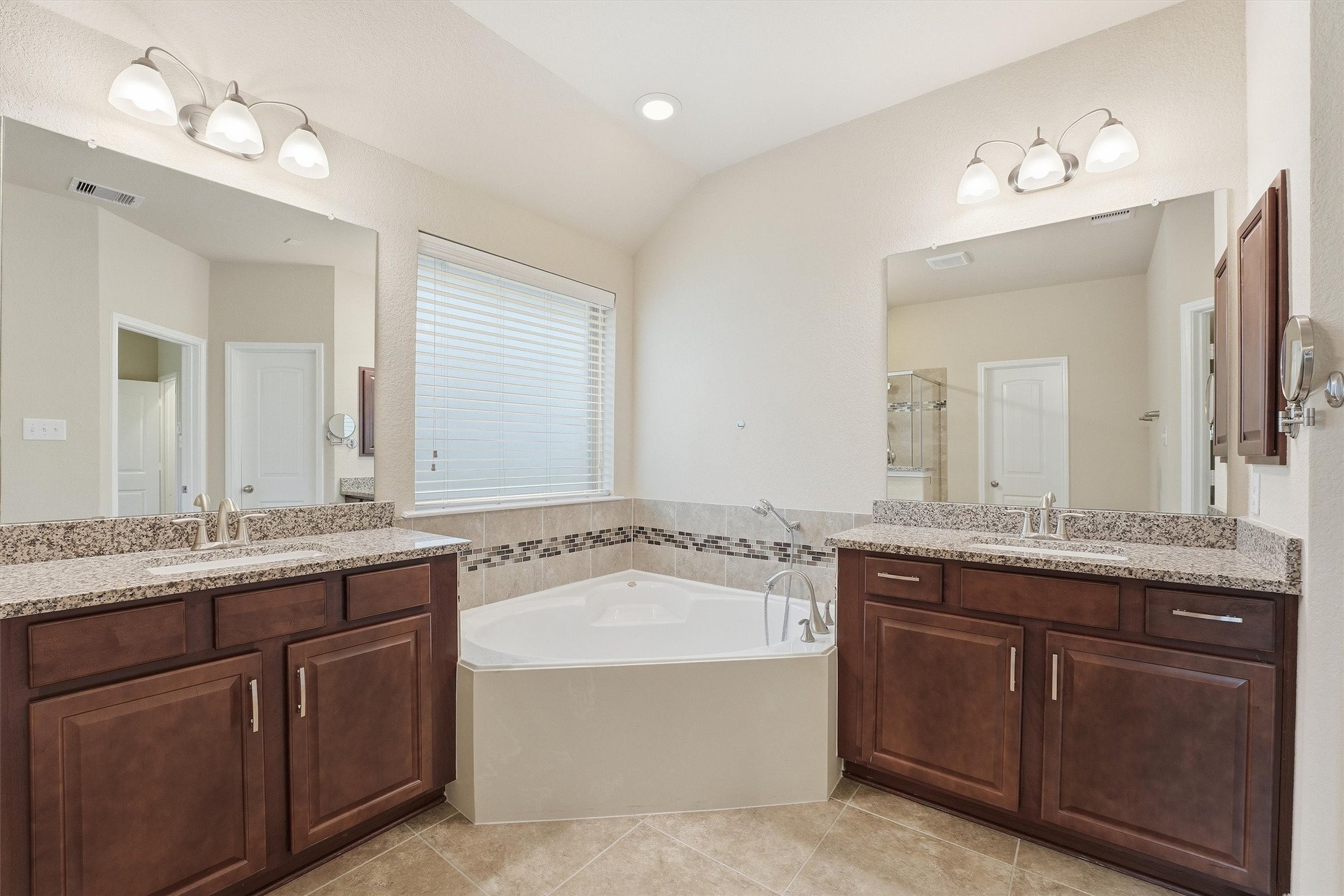1911 Cedar Ridge Lane Pearland, TX 77089 - Photo 20 of 33 Primary bath with granite, double sinks, soaking tub, separate shower, and a large walk-in closet.