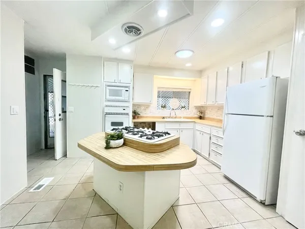 a kitchen with a refrigerator and a stove