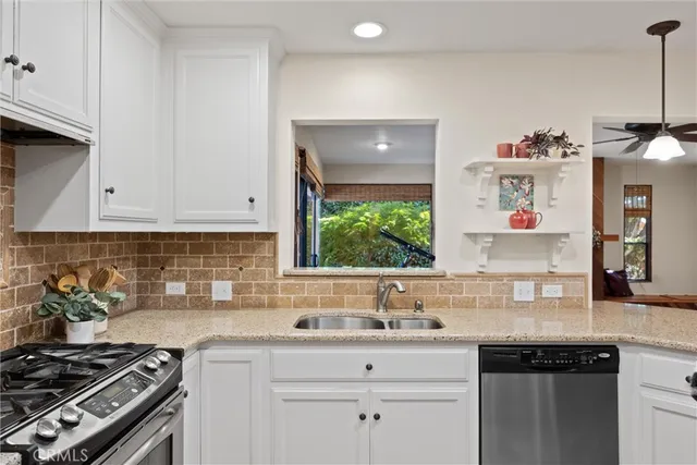 a kitchen with a sink stove and cabinets