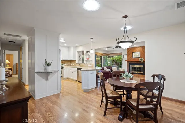 a open dining room with stainless steel appliances kitchen island granite countertop furniture and a kitchen view