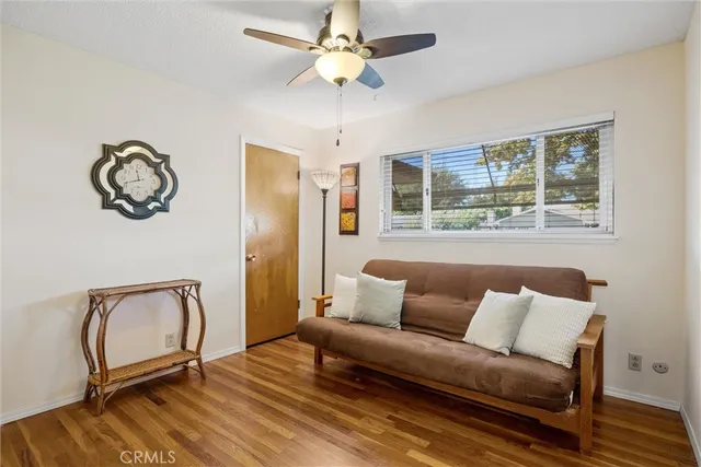 a living room with furniture a window and a chandelier