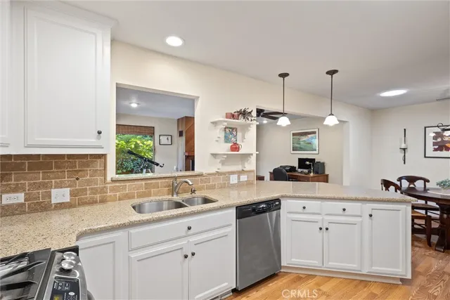a kitchen with a sink stove and cabinets