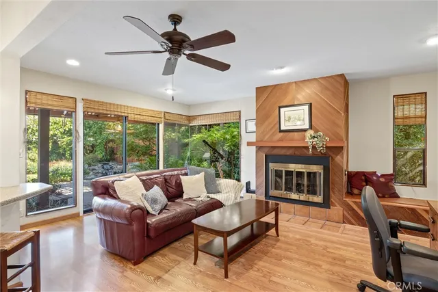 a living room with furniture a fireplace and a large window