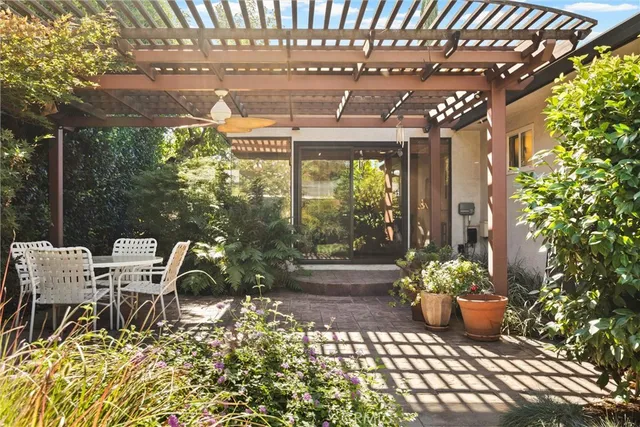a view of a patio with table and chairs and potted plants