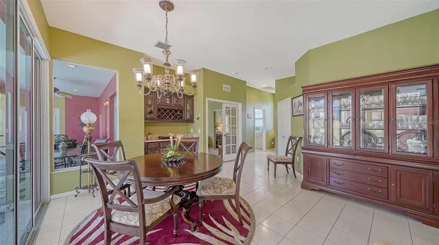a dining room with furniture a chandelier and window
