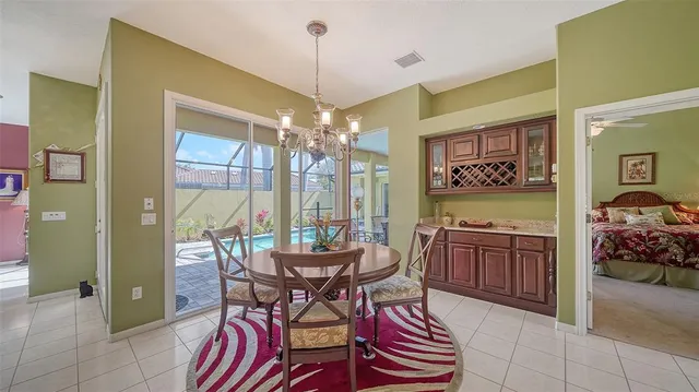 a view of a dining room with furniture large windows and wooden floor