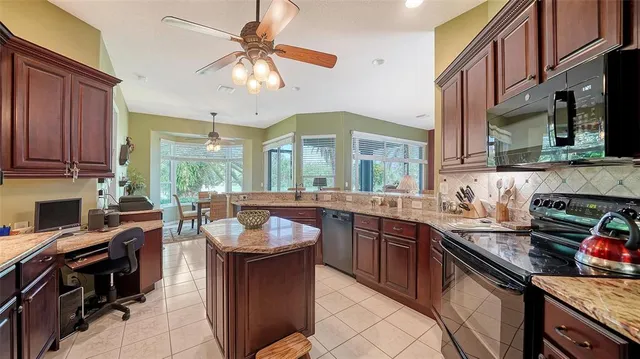 a kitchen with granite countertop a sink and cabinets
