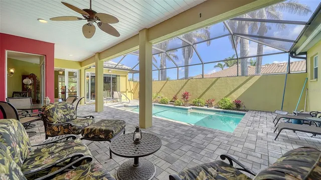 a living room with patio furniture and a wooden floor