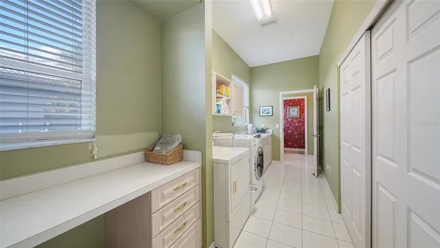 a view of a livingroom with workspace and a window