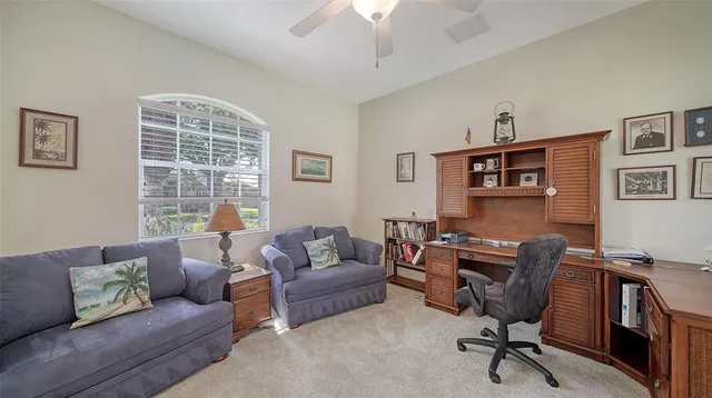 an aerial view of a house with swimming pool and large trees