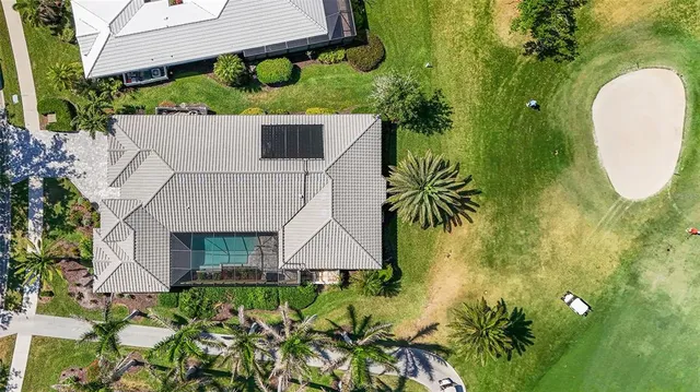 a view of a house with a yard and sitting area