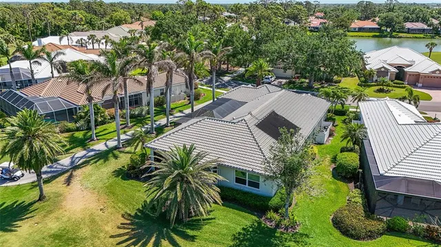 an aerial view of a houses with a lake view