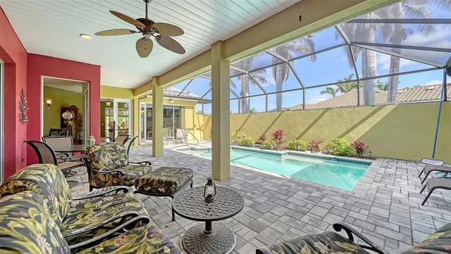 a view of a patio with table and chairs under an umbrella