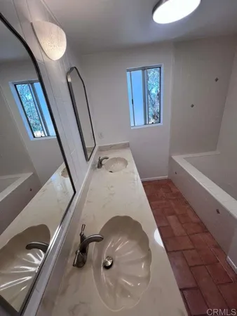 a view of a livingroom with wooden floor and furniture