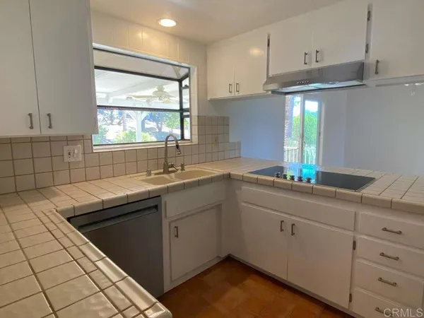 a kitchen with a sink and cabinets