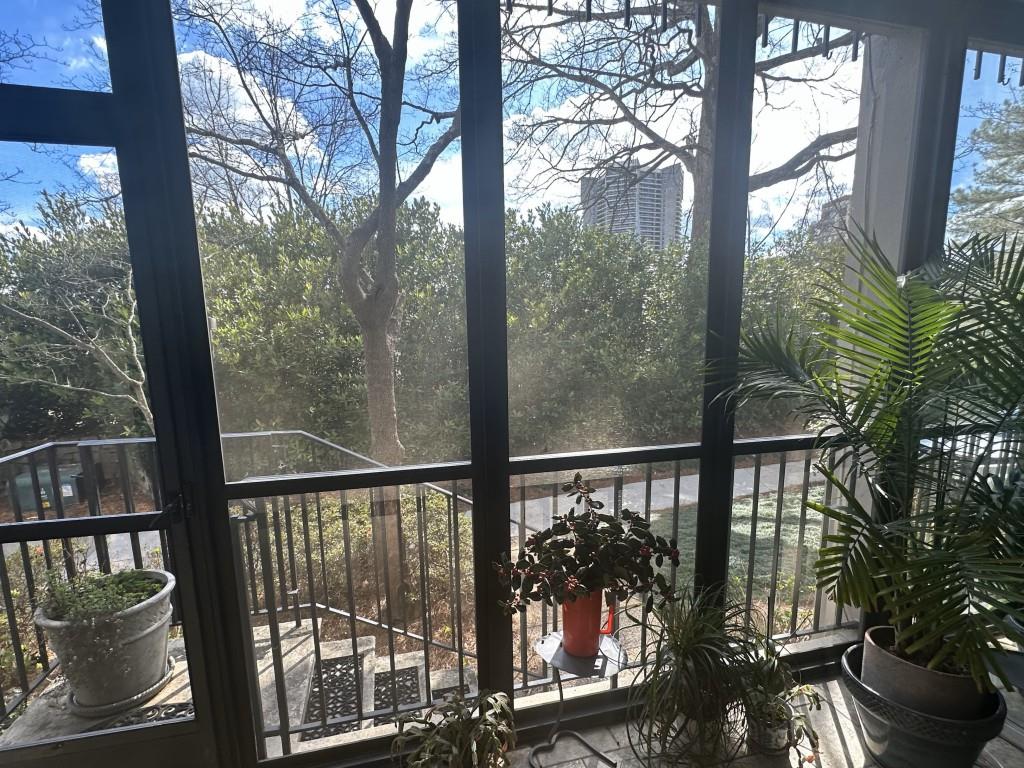 a view of a balcony with a yard