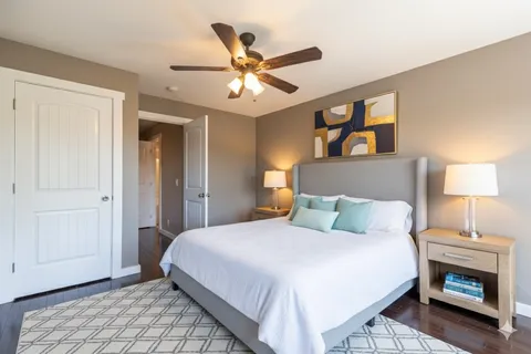 a bedroom with a bed and a chandelier