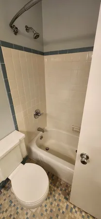 a bathroom with a toilet and a shower