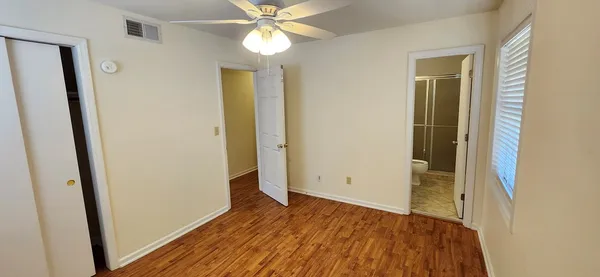 wooden floor in an empty room with a mirror