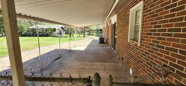a view of a porch with wooden floor and fence
