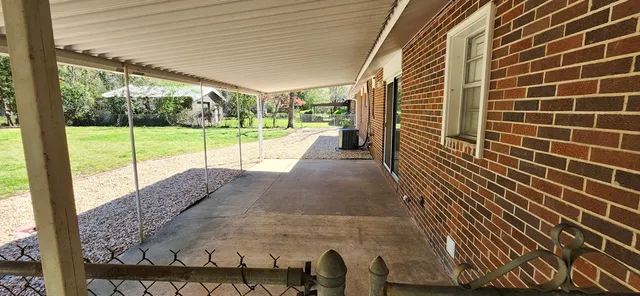 a view of a porch with wooden floor and fence