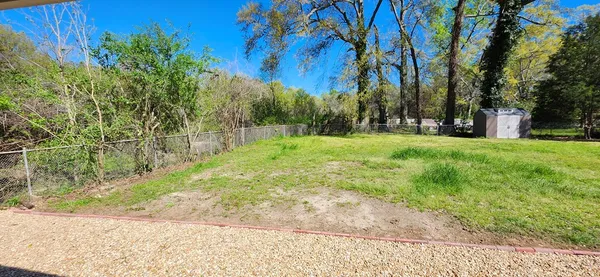 a view of a yard with trees