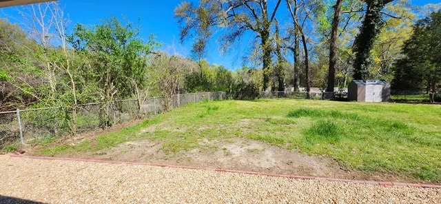 a view of a yard with trees