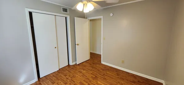 a view of hallway with wooden floor