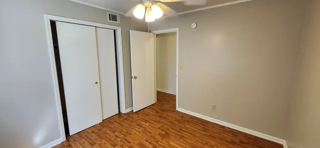 a view of hallway with wooden floor