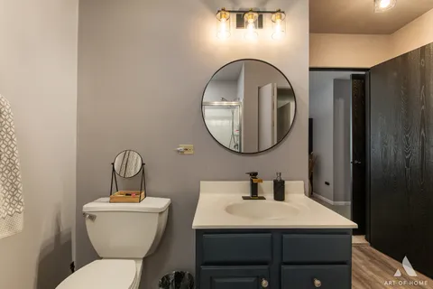 a bathroom with a toilet a sink and a mirror
