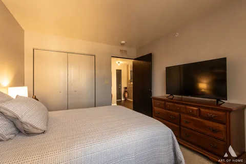 a bedroom with a bed and a flat screen tv