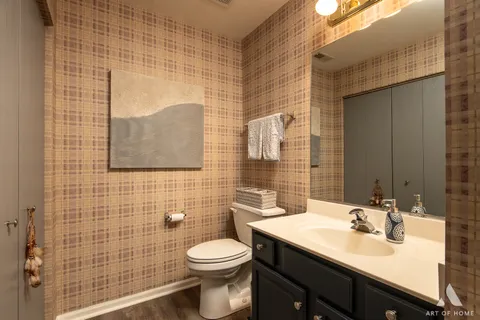 a bathroom with a sink a toilet and mirror