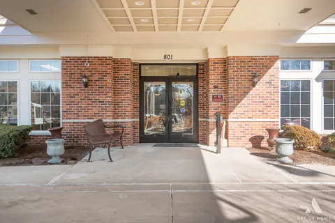 a building outdoor space with patio furniture and potted plants