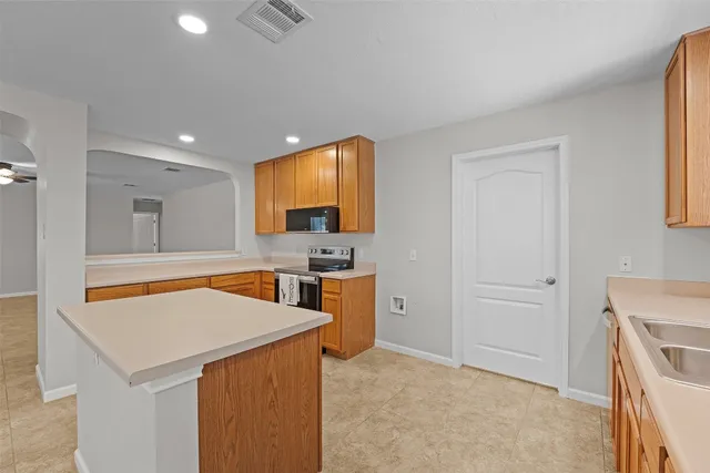 a view of a kitchen with a sink and cabinets