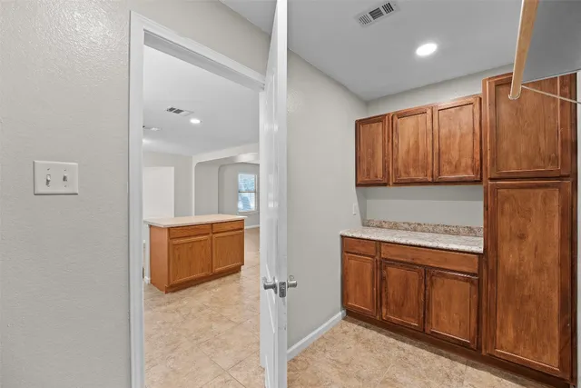 a view of kitchen with furniture and electronic appliances
