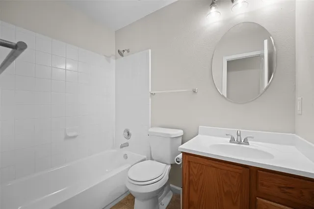 a bathroom with a double vanity sink a toilet and a bathtub