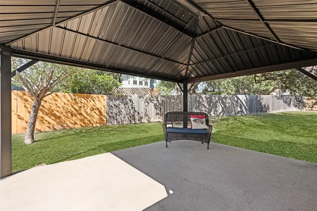 a view of a backyard with wooden fence